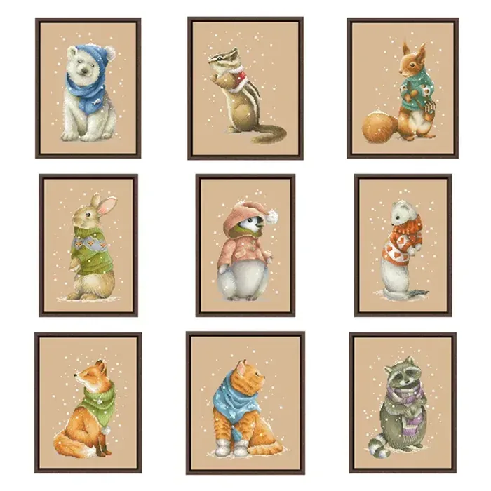 All nine Little Animals designs framed: white bear, chipmunk, squirrel, rabbit, penguin, mink, winter fox, winter cat and raccoon in knitwear