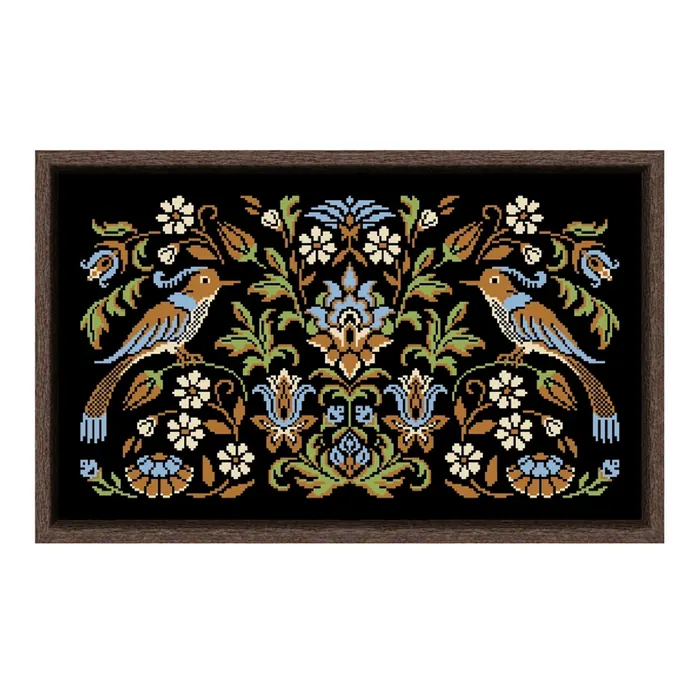 The Turquoise Bird Night Songs design framed in dark wood: two perched folk birds with pale blue breasts among cream and blue flowers on black fabric